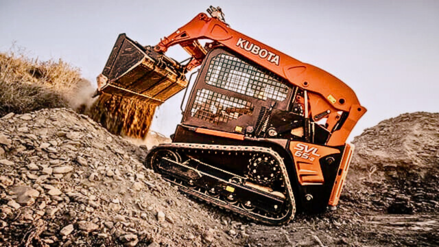 Skid steer loader operating a 4-in-1 bucket in a construction site.