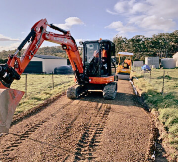 An excavator from Dynamic Earth Solutions efficiently performing excavation work at a construction site.