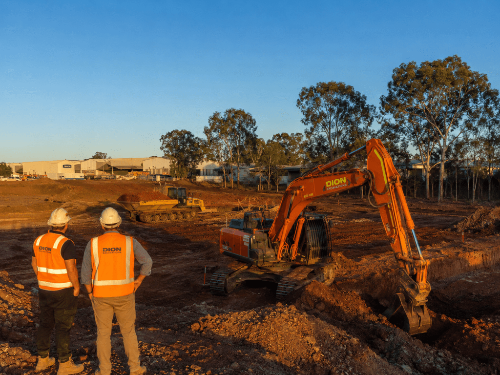 Commercial excavation south east Brisbane industrial estate with excavator and workers in hi-vis