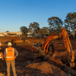 Commercial excavation south east Brisbane industrial estate with excavator and workers in hi-vis