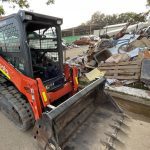 Dynamic Earth Solutions Kubota skid steer loading a pile of demolition and clean-up debris on a south-east Queensland job