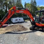 Dynamic Earth Solutions Kubota excavator stockpiling spoil on a residential excavation job