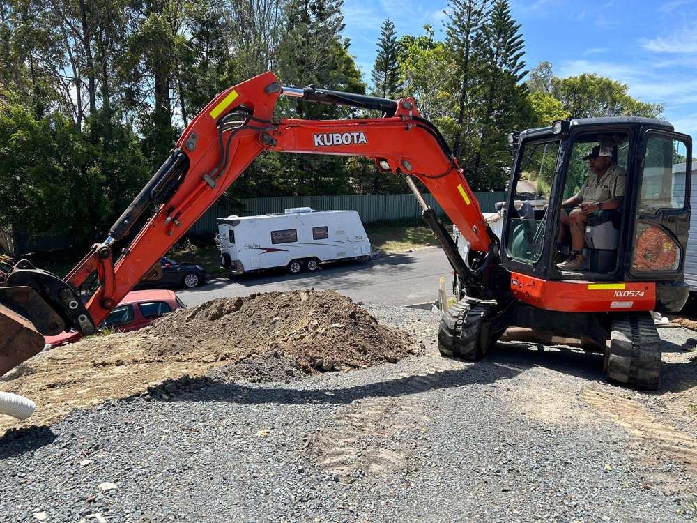 Dynamic Earth Solutions Kubota excavator stockpiling spoil on a residential excavation job