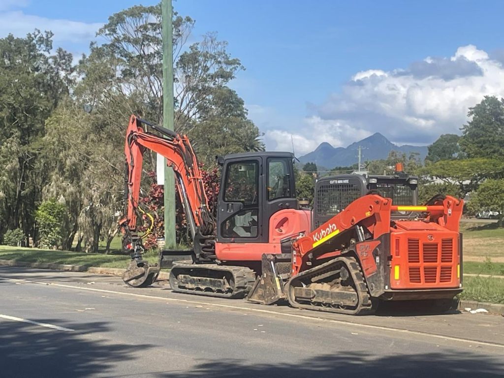 Dynamic Earth Solutions Kubota excavator and skid steer parked kerbside before a site cut in south Brisbane