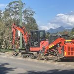 Dynamic Earth Solutions Kubota excavator and skid steer parked kerbside before a site cut in south Brisbane